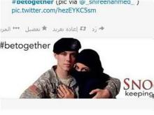 صورة جندي امريكي يحتضن امرأة مسلمة يتفجر عاصفة تعليقات